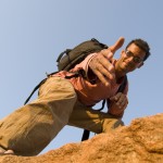 iStock- man at top of rock